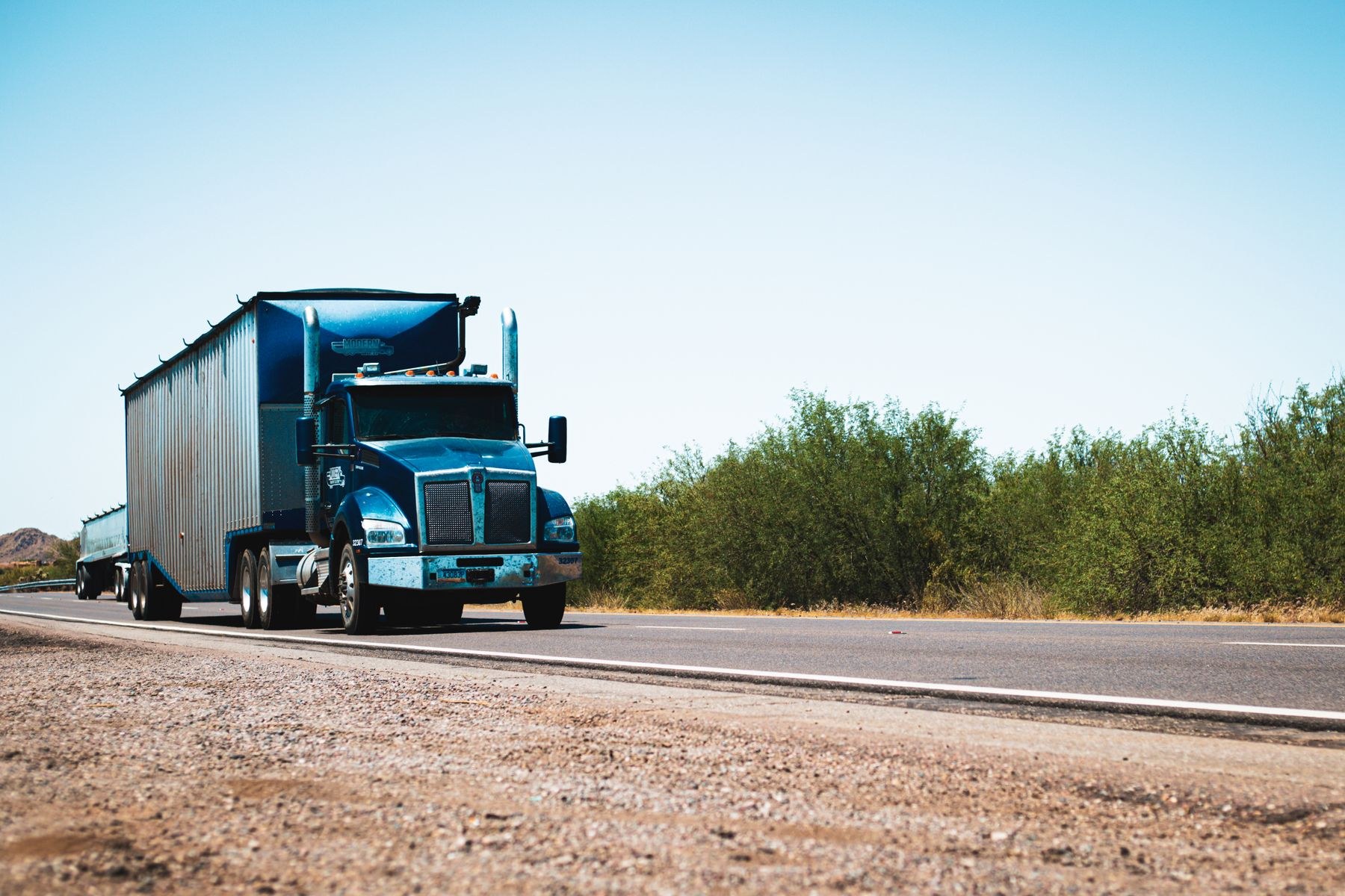 American semi truck hauling freight on an open road